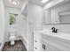 Bright bathroom featuring a modern vanity, sleek black faucet, and tiled tub at 4274 Smithsonia Ct, Tucker, GA 30084