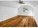 Bright bedroom featuring hardwood floors, a ceiling fan, and a bright window with outdoor views at 4274 Smithsonia Ct, Tucker, GA 30084
