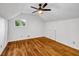 Cozy bedroom featuring hardwood floors, a ceiling fan, and a bright window with outdoor views at 4274 Smithsonia Ct, Tucker, GA 30084