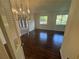 Dining room boasting hardwood floors, classic chandelier, and ample natural light at 4274 Smithsonia Ct, Tucker, GA 30084
