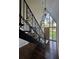 Inviting foyer with hardwood floors, decorative lighting and a custom wrought iron staircase at 4274 Smithsonia Ct, Tucker, GA 30084