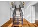 Grand foyer featuring wooden stairs with iron railing, hardwood floors, and modern pendant lights at 4274 Smithsonia Ct, Tucker, GA 30084