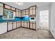 A functional kitchen with light wood cabinets, blue countertops, and classic appliances at 4274 Smithsonia Ct, Tucker, GA 30084