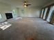 Spacious living room featuring a fireplace, large windows and neutral colored carpet at 4274 Smithsonia Ct, Tucker, GA 30084