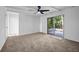 Bright room with ceiling fan and sliding doors to backyard patio at 4274 Smithsonia Ct, Tucker, GA 30084