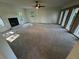 Bright living room featuring a fireplace, ceiling fan, and unique brick wall with decorative window coverings at 4274 Smithsonia Ct, Tucker, GA 30084
