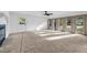Sun-filled living room with large windows, neutral carpet, and a cozy fireplace at 4274 Smithsonia Ct, Tucker, GA 30084