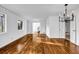 Bright living room with gleaming hardwood floors, a modern chandelier, and white walls at 4274 Smithsonia Ct, Tucker, GA 30084