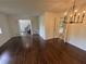 Open living room with hardwood floors, a chandelier, and views into additional living spaces at 4274 Smithsonia Ct, Tucker, GA 30084