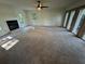 Bright living room featuring a fireplace, ceiling fan, and unique brick wall with decorative window coverings at 4274 Smithsonia Ct, Tucker, GA 30084