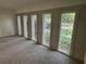 Sunlit living room showcasing a brick wall with decorative iron window coverings and neutral carpet at 4274 Smithsonia Ct, Tucker, GA 30084