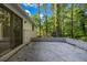 Back patio area with brick accents, sliding glass doors, and a view of the wooded surroundings at 4274 Smithsonia Ct, Tucker, GA 30084