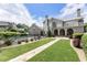 Spacious backyard with in-ground pool, stone patio, lush lawn, and meticulous landscaping at 4830 Westgate Dr, Cumming, GA 30040