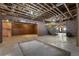 Unfinished basement offering ample space with exposed ceiling, brick accent walls, and staircase access at 4830 Westgate Dr, Cumming, GA 30040