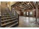 Partially finished basement featuring exposed ceiling beams, brick walls, and natural light from multiple windows at 4830 Westgate Dr, Cumming, GA 30040
