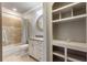 Bright bathroom with tub/shower combo, built in shelving, and stylish vanity at 4830 Westgate Dr, Cumming, GA 30040