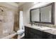 Neutral bathroom with a tiled shower, framed mirror and a single sink vanity at 4830 Westgate Dr, Cumming, GA 30040