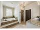 Bathroom showcasing a tiled tub, glass shower, granite countertop, and neutral color palette at 4830 Westgate Dr, Cumming, GA 30040