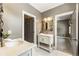Well-lit bathroom featuring double vanity, patterned mirror, and access to a bedroom at 4830 Westgate Dr, Cumming, GA 30040