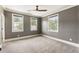 Gray bedroom with three windows, carpet, and ceiling fan at 4830 Westgate Dr, Cumming, GA 30040