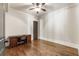 Bright bedroom with hardwood floors, neutral walls, and a classic wooden desk at 4830 Westgate Dr, Cumming, GA 30040