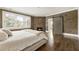 Cozy bedroom features wood-paneled walls, a fireplace, and barn door access to the bathroom at 4830 Westgate Dr, Cumming, GA 30040