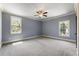 Light blue bedroom with carpet, crown moulding, and two large windows at 4830 Westgate Dr, Cumming, GA 30040