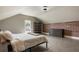Bright bedroom featuring a brick accent wall, wood floors, natural light, and a neutral color palette at 4830 Westgate Dr, Cumming, GA 30040