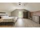 Bright bedroom with a comfortable bed, exposed brick wall, storage shelves, and natural light from a window at 4830 Westgate Dr, Cumming, GA 30040
