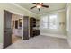 Bedroom features a ceiling fan, built in shelves and view into the bathroom at 4830 Westgate Dr, Cumming, GA 30040
