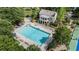Aerial view of a resort-style pool, complete with lounge chairs, umbrellas, and lush landscaping at 4830 Westgate Dr, Cumming, GA 30040