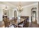 Spacious dining room featuring hardwood floors, chandeliers, and easy access to other rooms at 4830 Westgate Dr, Cumming, GA 30040