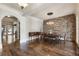 Elegant dining room featuring hardwood floors, brick accent wall, and stylish chandelier at 4830 Westgate Dr, Cumming, GA 30040