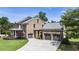 Spacious brick home featuring a well-manicured lawn and convenient three-car garage with a basketball hoop at 4830 Westgate Dr, Cumming, GA 30040