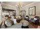 Open-concept living area with hardwood floors, stylish furnishings, and ample natural light at 4830 Westgate Dr, Cumming, GA 30040
