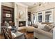 Elegant living room showcasing a fireplace, custom bookshelves, and hardwood floors at 4830 Westgate Dr, Cumming, GA 30040