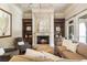 Cozy living room featuring a fireplace, built-in bookshelves, and comfortable seating at 4830 Westgate Dr, Cumming, GA 30040