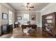 Spacious home office with beautiful hardwood floors, natural light, and built-in bookcase at 4830 Westgate Dr, Cumming, GA 30040