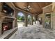 Spacious covered patio featuring a fireplace, brick arches, and a built-in grill area at 4830 Westgate Dr, Cumming, GA 30040