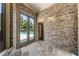Covered patio with brick walls and access to the pool via glass doors, creating a seamless indoor-outdoor transition at 4830 Westgate Dr, Cumming, GA 30040