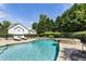 Beautiful pool area featuring a jacuzzi, lounge chairs and privacy landscaping, perfect for relaxation at 4830 Westgate Dr, Cumming, GA 30040