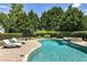 Backyard oasis featuring a beautiful pool, hot tub, and lounge chairs for relaxing by the water at 4830 Westgate Dr, Cumming, GA 30040