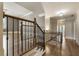 Elegant staircase with hardwood steps and decorative wrought iron railing leads to upper level living spaces at 4830 Westgate Dr, Cumming, GA 30040