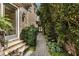 Stone walkway alongside brick home with lush greenery leading to a glass door at 4830 Westgate Dr, Cumming, GA 30040