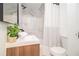 Modern bathroom with a wood vanity, white countertop and white marble walls at 1227 Epworth Sw St, Atlanta, GA 30310