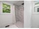 Modern bathroom featuring a tiled shower with a rainfall showerhead and a glass partition at 1227 Epworth Sw St, Atlanta, GA 30310