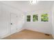 Bright bedroom with hardwood floors, white walls, and natural light from three windows at 1227 Epworth Sw St, Atlanta, GA 30310