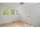 Sunlit bedroom featuring three windows, white walls, and hardwood flooring at 1227 Epworth Sw St, Atlanta, GA 30310