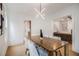 Dining room with modern light fixture, open to the living room, and with seating for four at 1227 Epworth Sw St, Atlanta, GA 30310