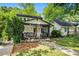 Charming home with a cozy front porch, stone foundation and a manicured lawn at 1227 Epworth Sw St, Atlanta, GA 30310